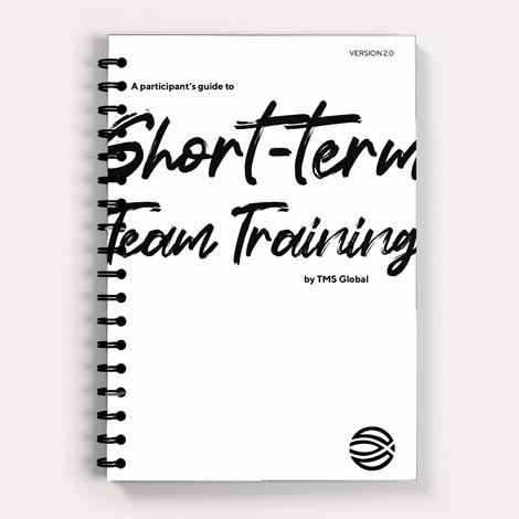 Short Term Team Training books in a stack. There is a rowing team on the cover.